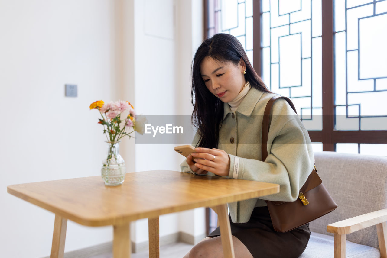 Businesswoman using phone at office