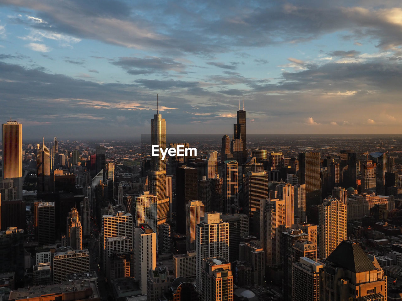 Aerial view of modern buildings in city against sky