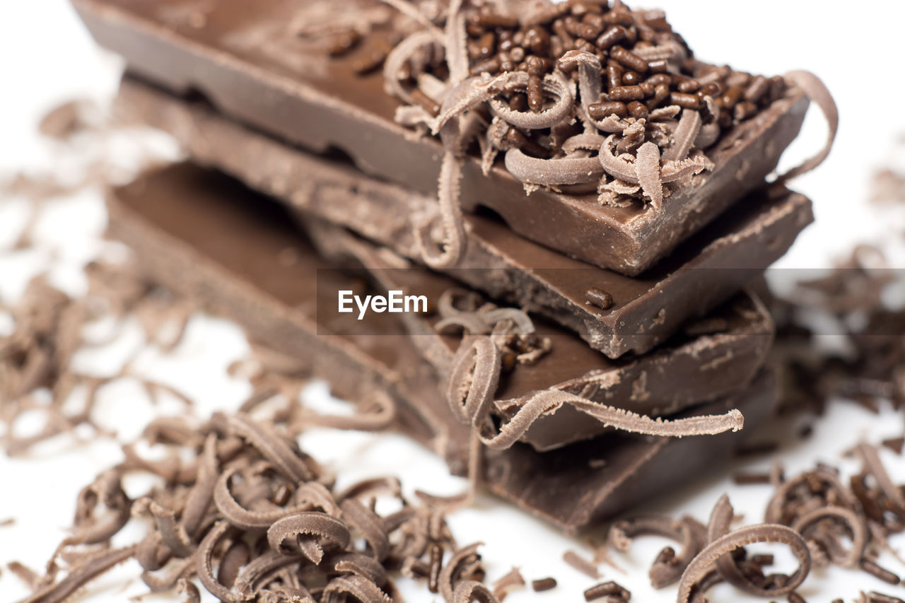 Close-up of stacked chocolate bars with shavings