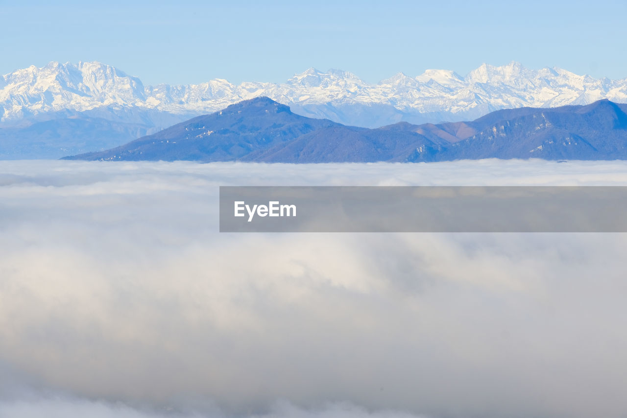 A sea of fog over the city of como and lake como, from a panoramic viewpoint in brunate.