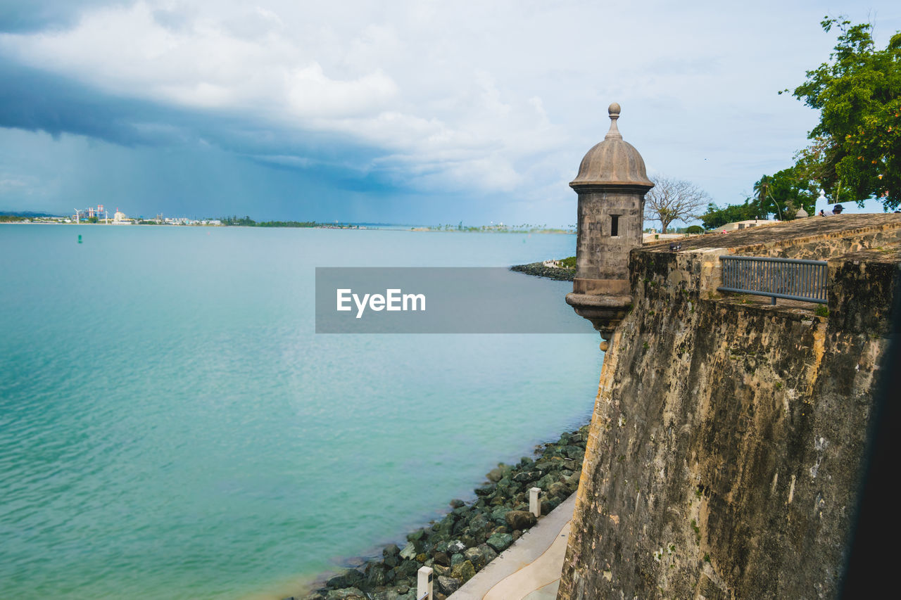 Scenic view of sea by building against sky