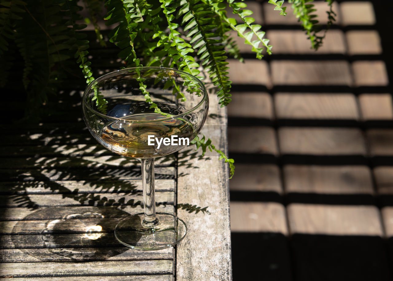 Glass on weathered patio table.