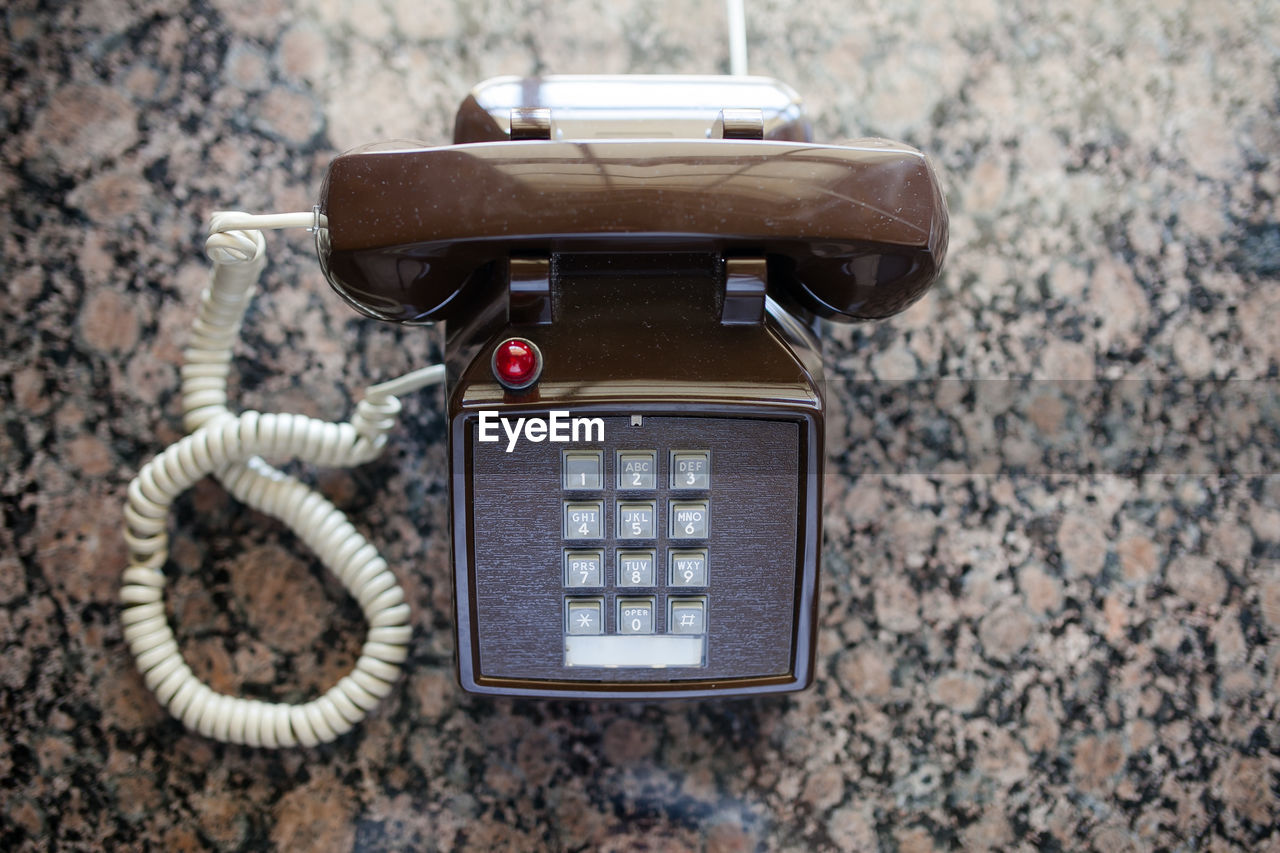 Directly above view of old-fashioned telephone on table