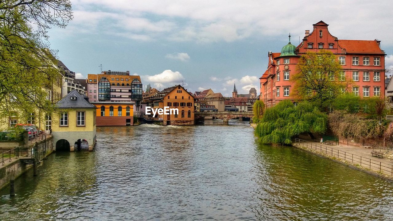 River amidst buildings against sky