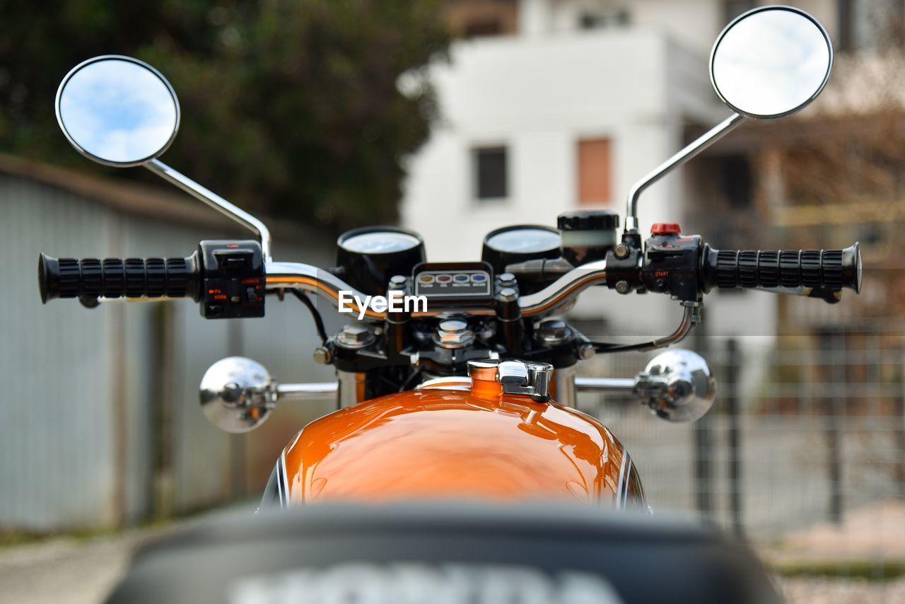 Close-up of motocycle on street