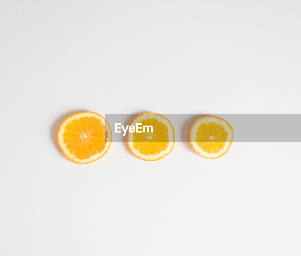 Directly above shot of orange slices on white background