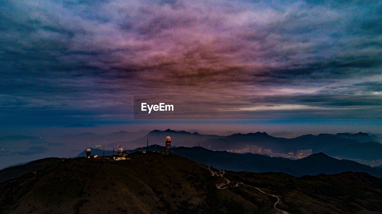 Scenic view of mountains against sky at sunset