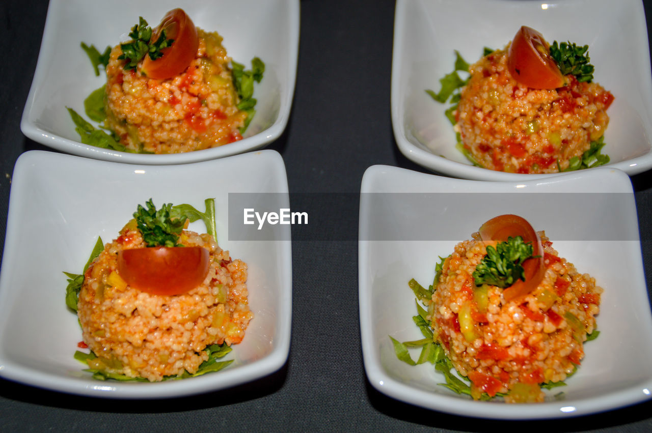 Close-up of couscous salad in plates on table for starters