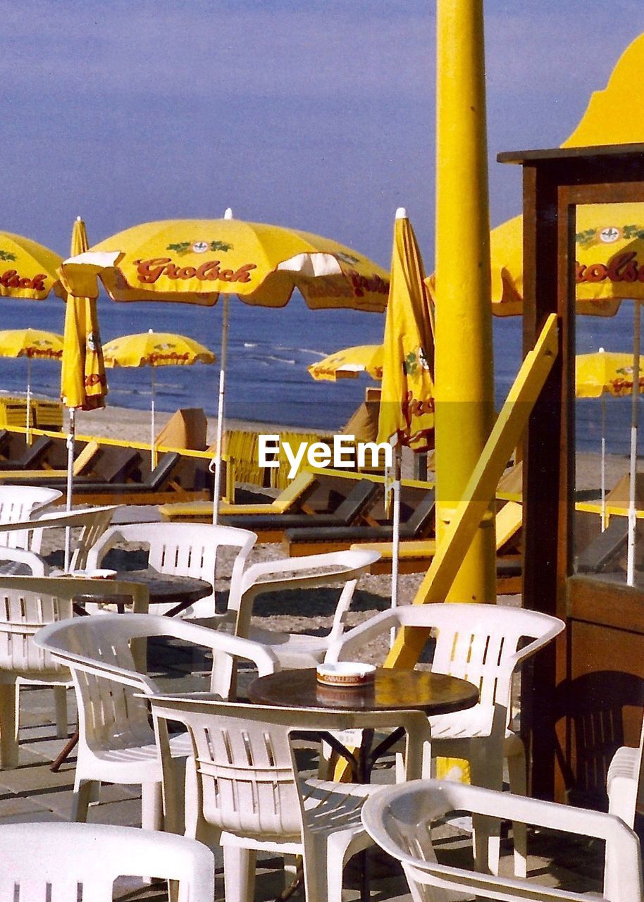 CHAIRS AND TABLE AT BEACH