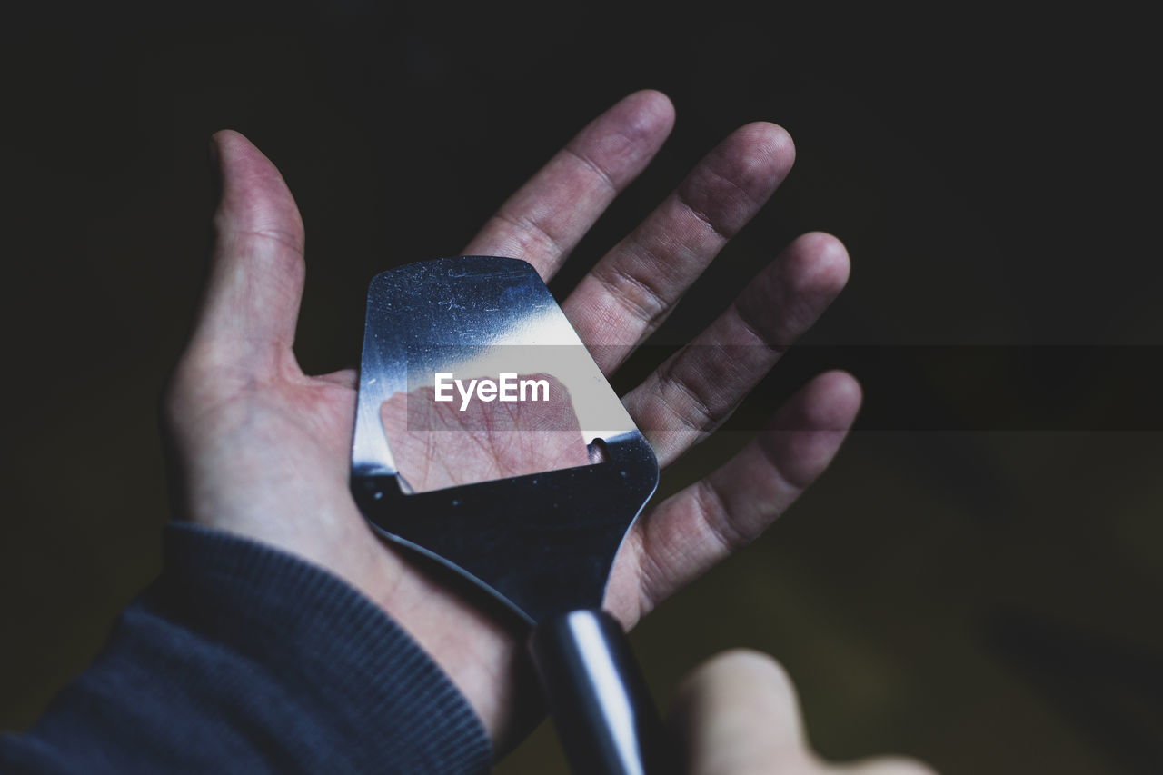Digital composite image of person peeling skin with utensil