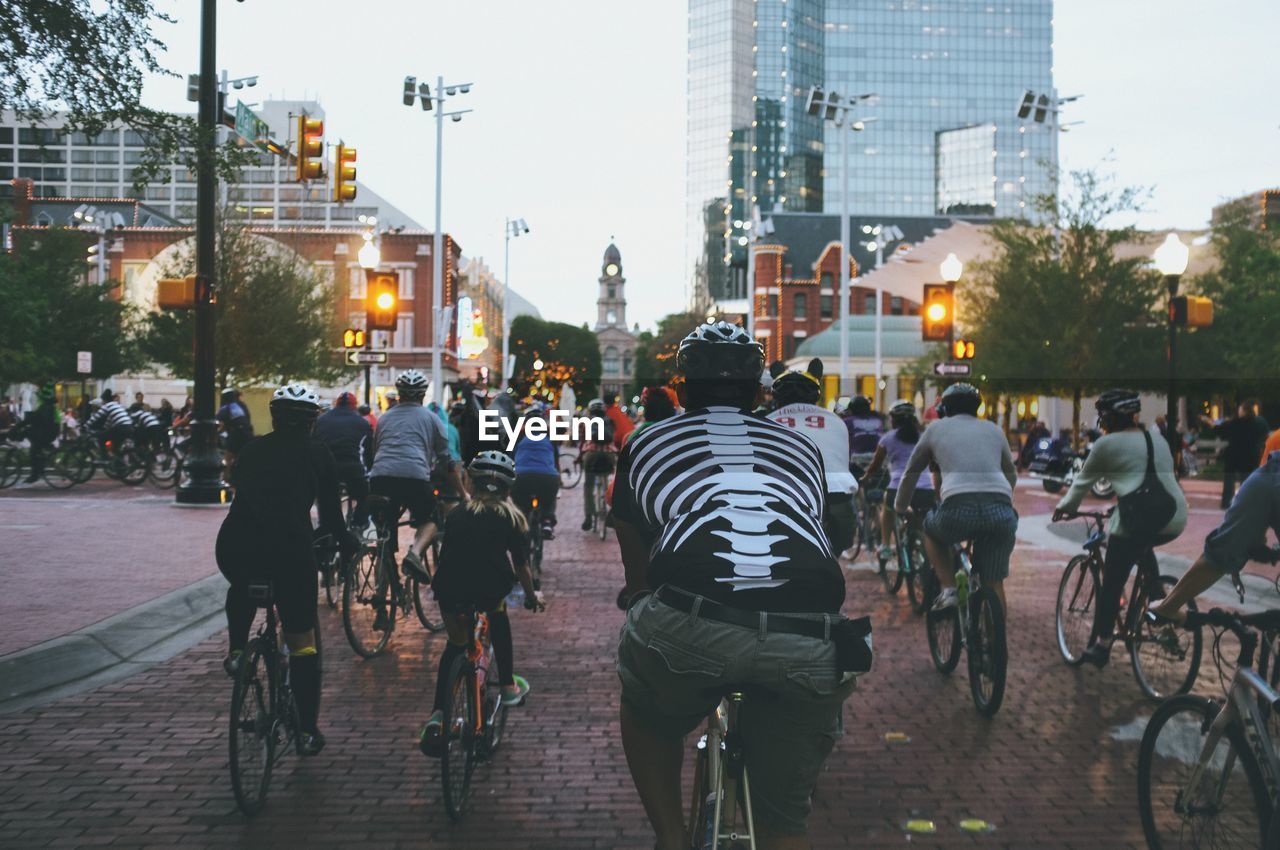 Rear view of cyclists on city street
