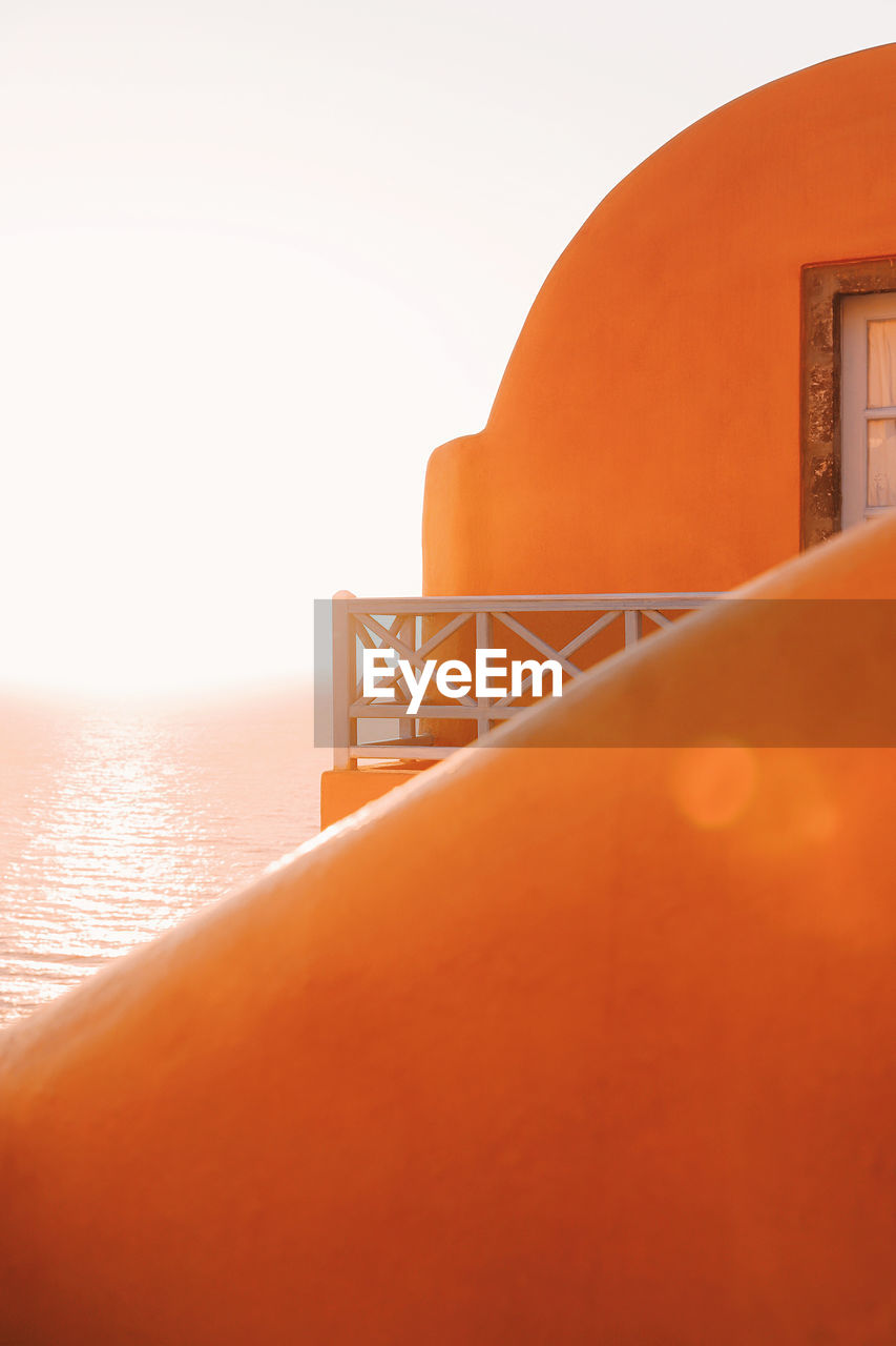 Close-up of sea against clear sky during sunset