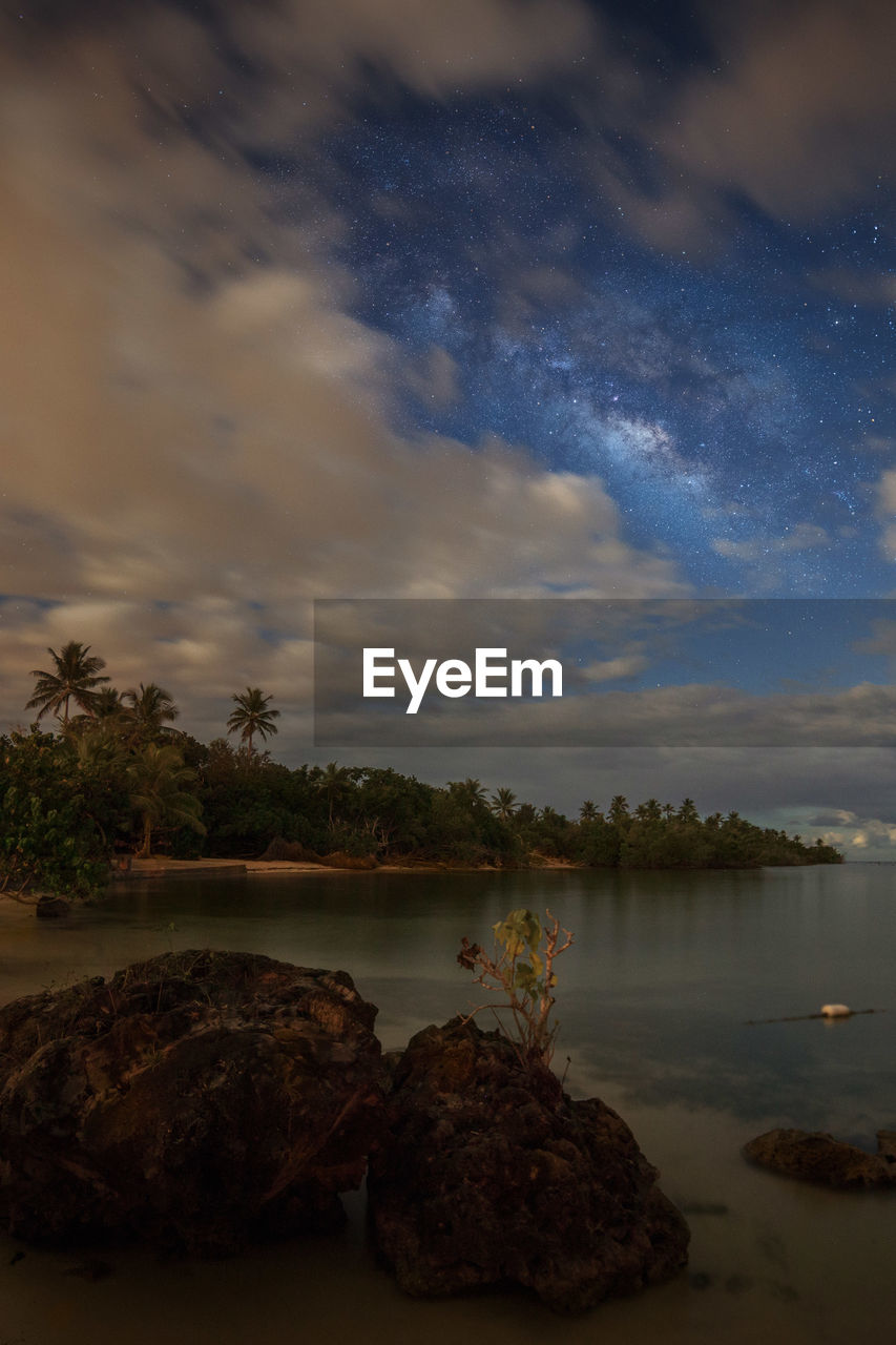 Scenic view of lake against sky at night