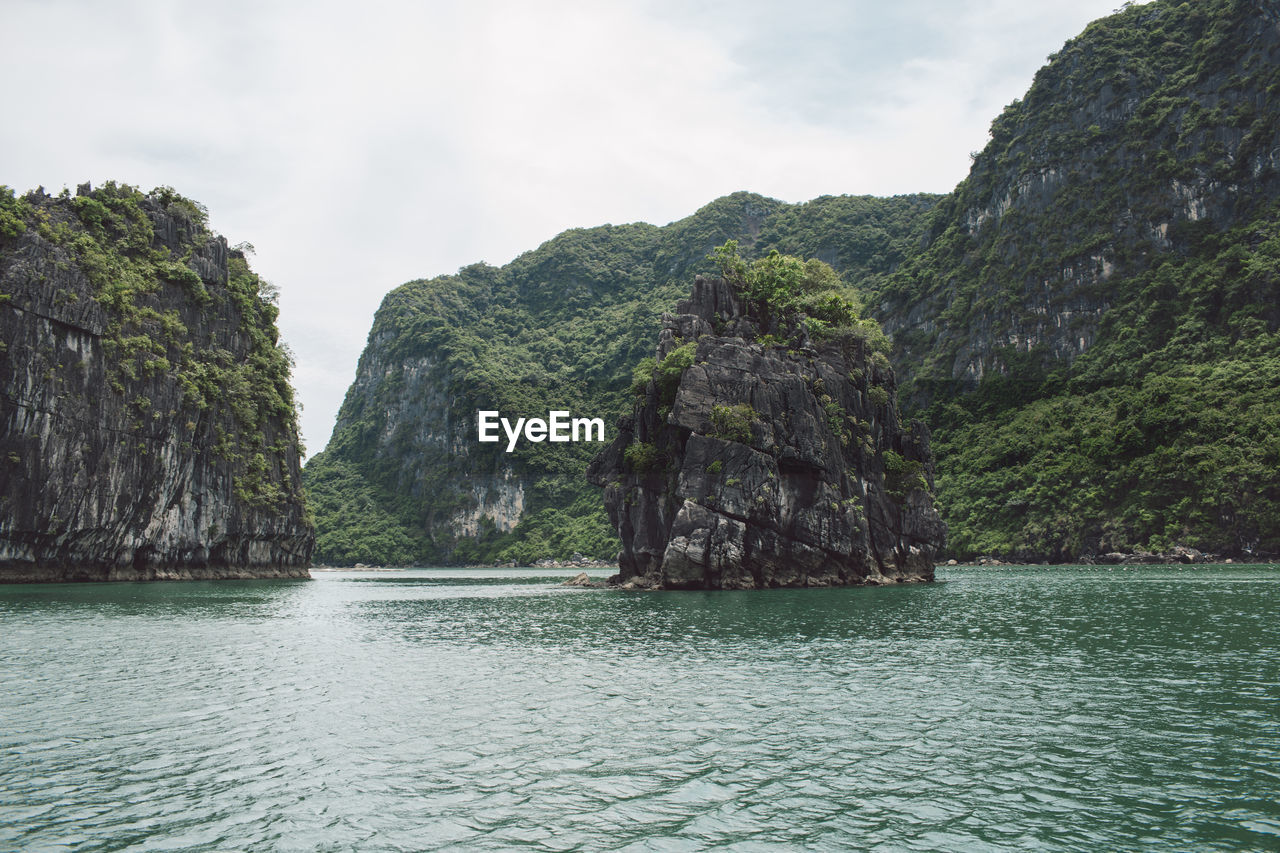 Scenic view of rock formation in sea against sky