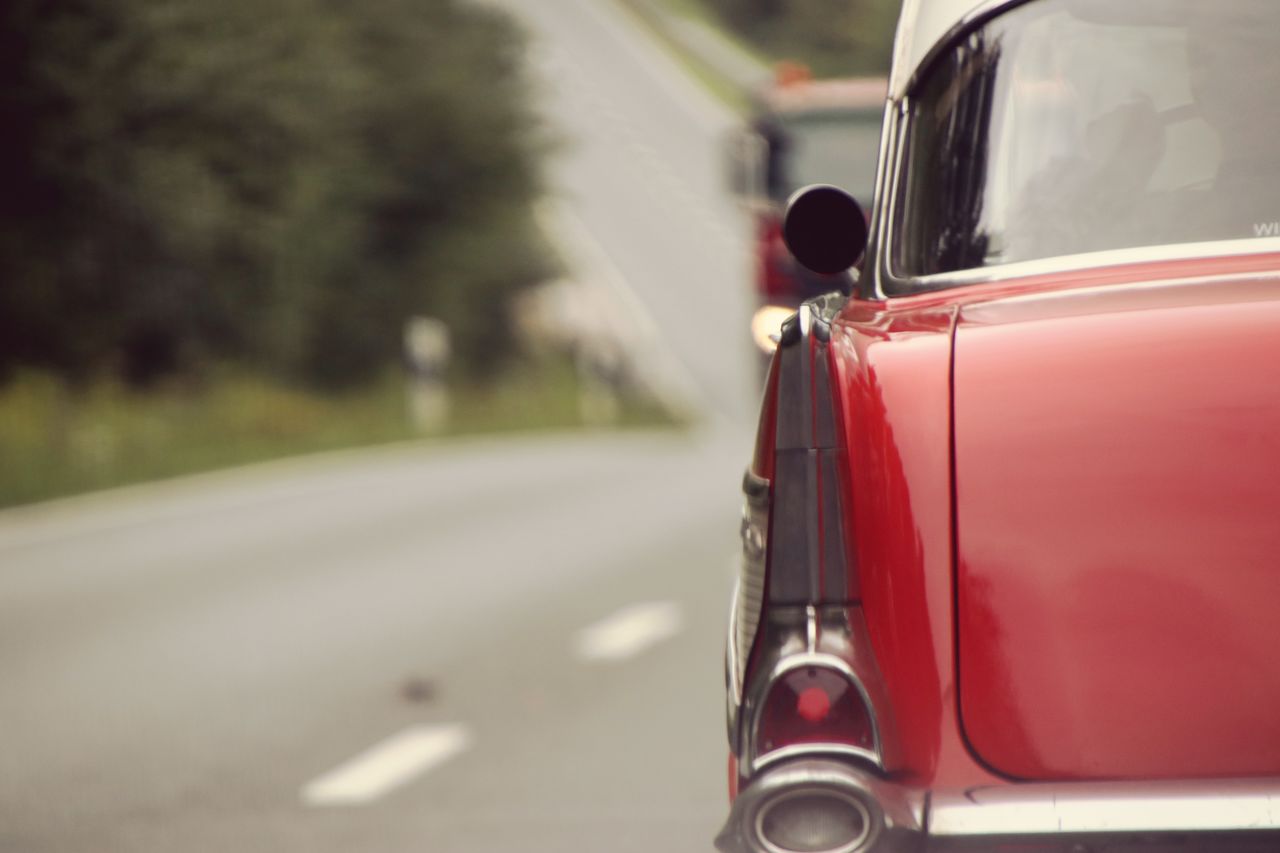 Close-up of red car on road