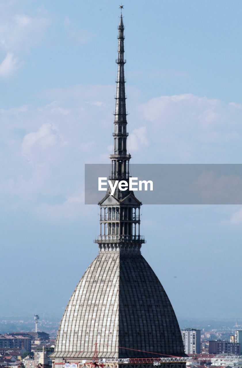 Spire of church in city against sky