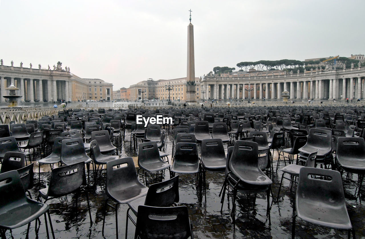 Empty wet chairs at st peter basilica