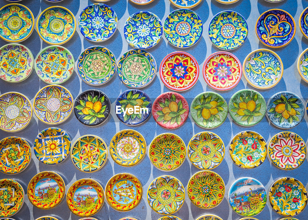 Directly above shot of colorful plates for sale at market stall