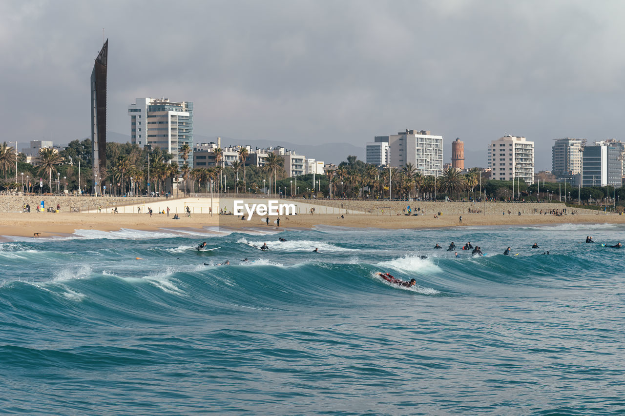 PANORAMIC VIEW OF SEA AGAINST BUILDINGS IN CITY