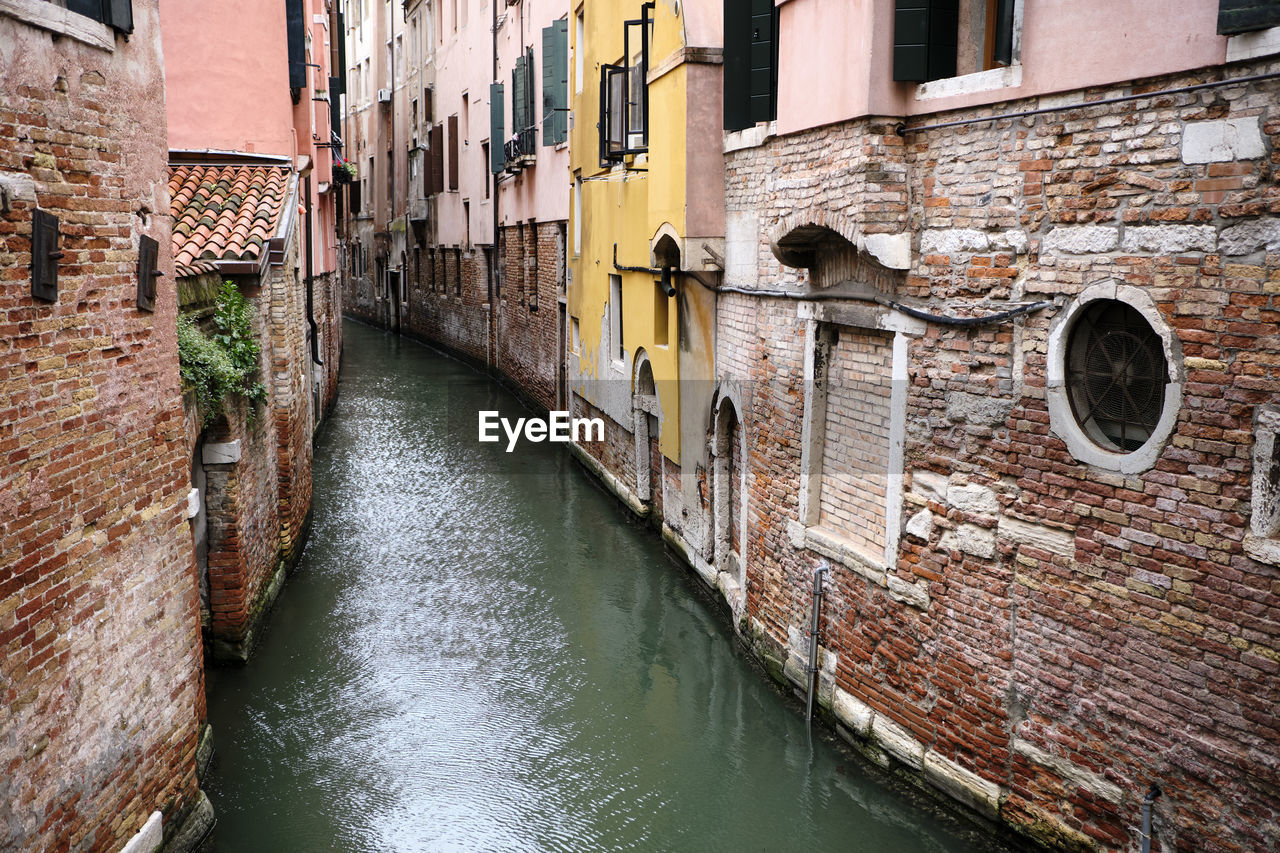 Canal amidst buildings in city