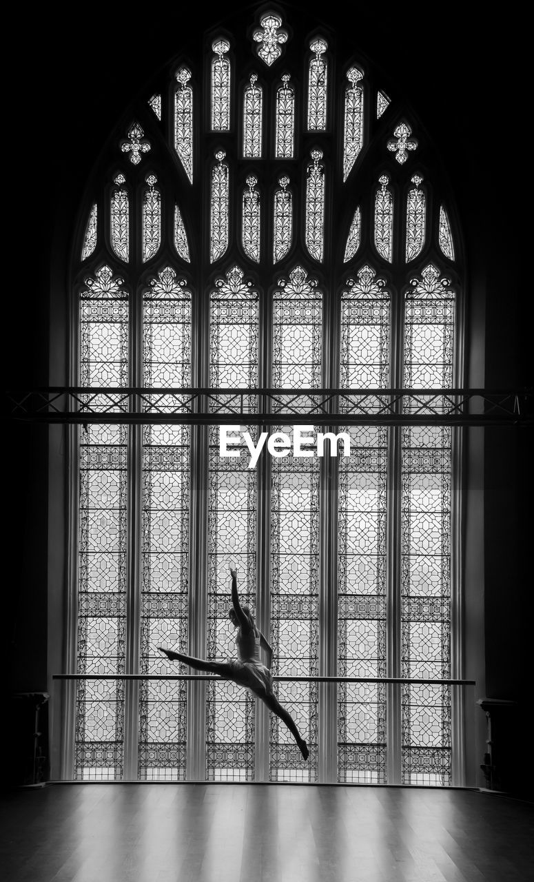 Ballet dancer in front of window
