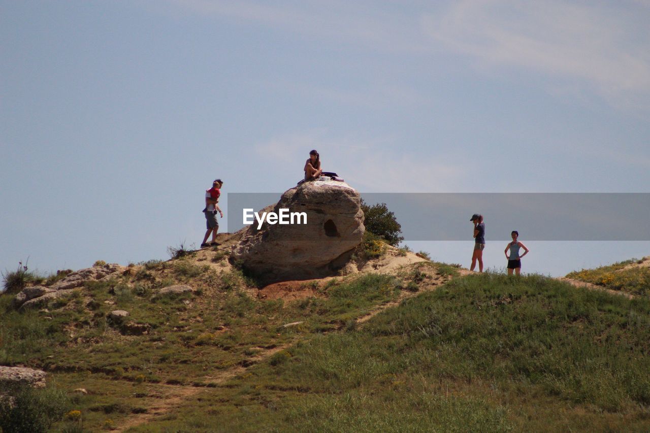 PEOPLE STANDING ON LAND ALONG SIDE