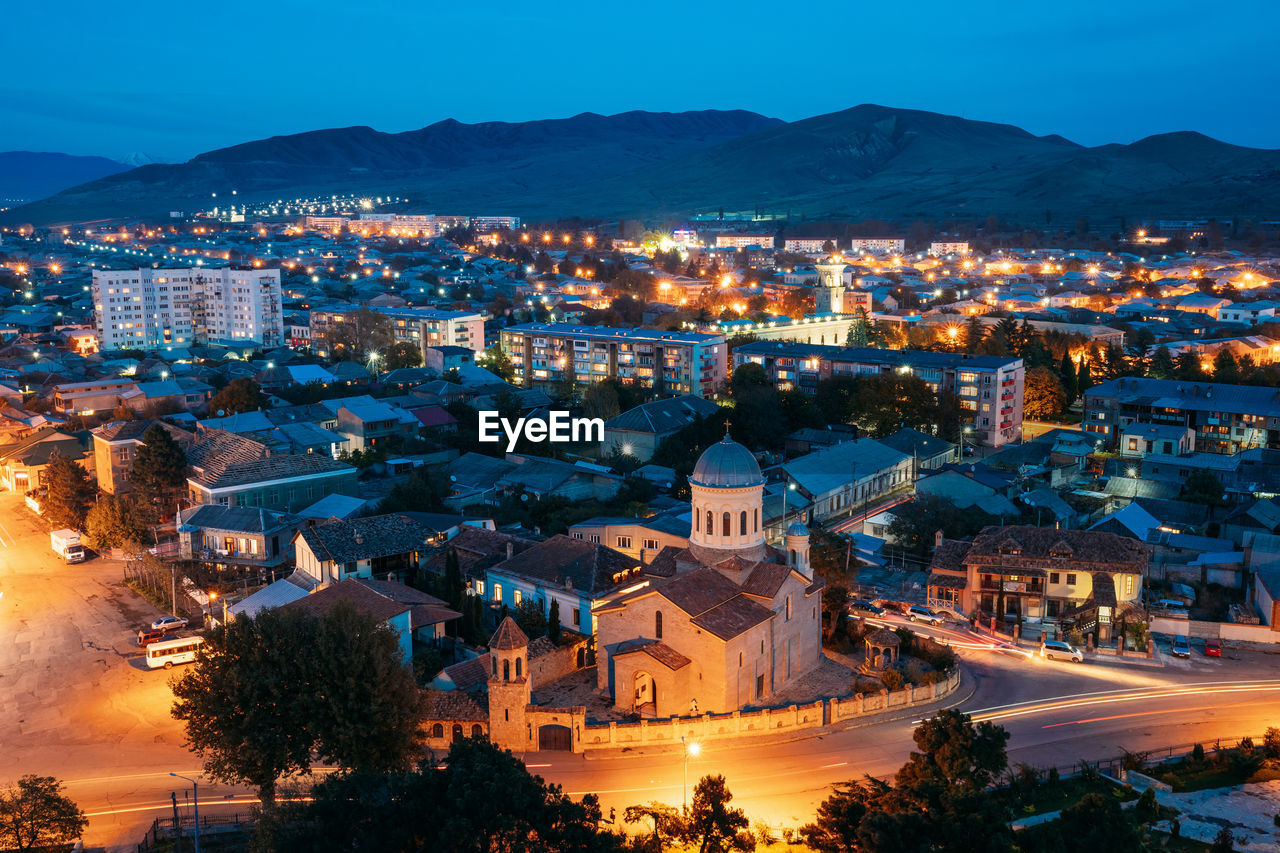 High angle view of illuminated buildings in city at night