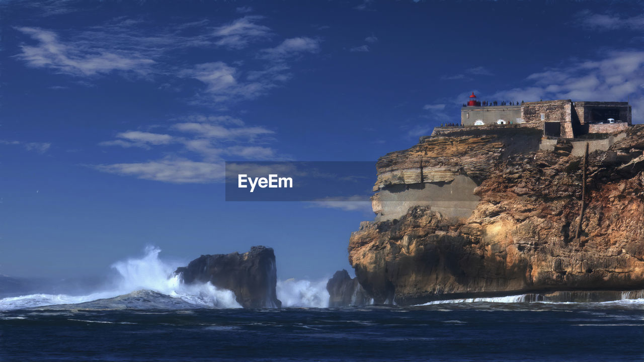 Painterly rendering of the rock and forte de são miguel arcanjo in nazare, potugal