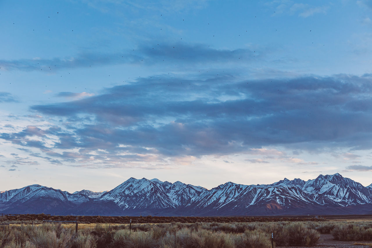 Dramatic sky over arid plains against sierra nevada mountains in the owens river valley 