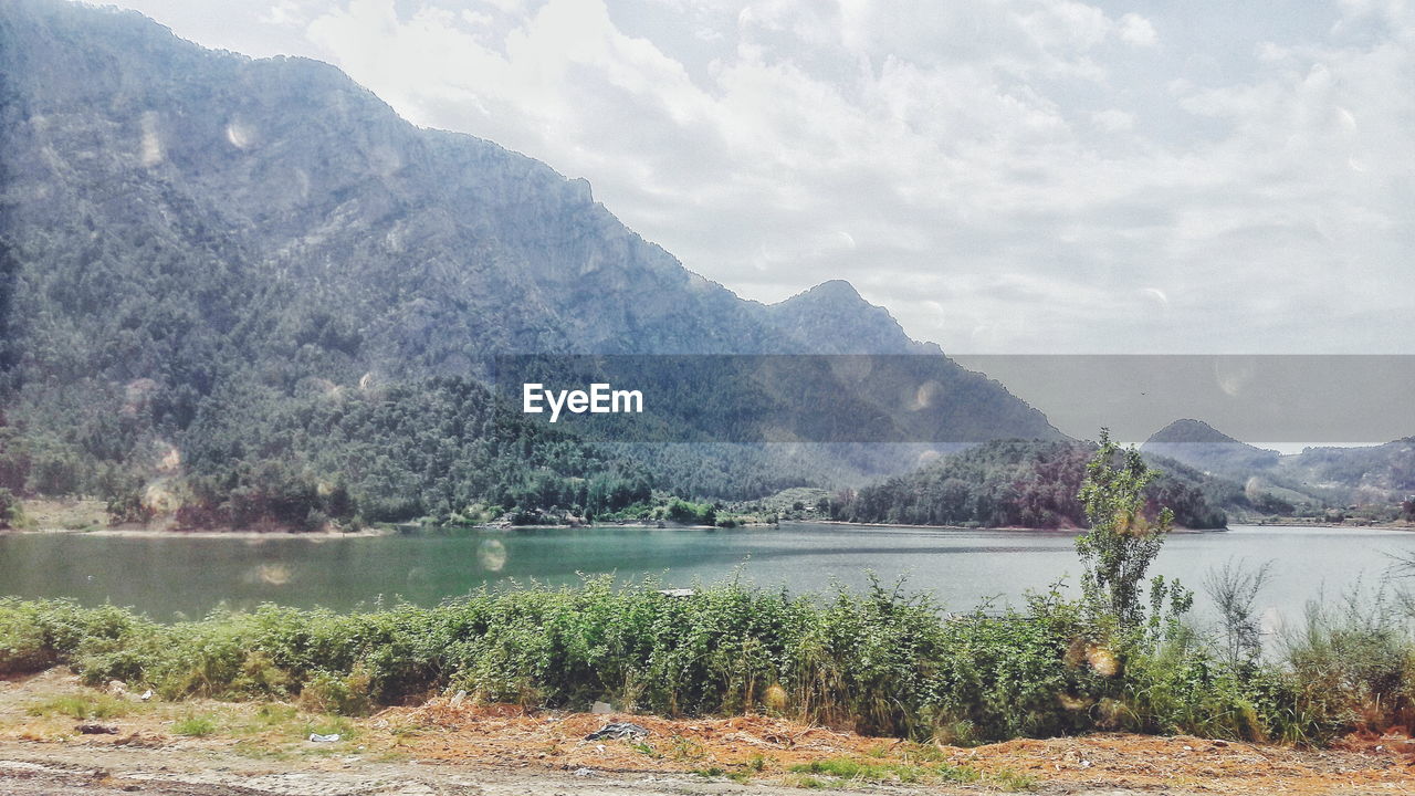 SCENIC VIEW OF LAKE AGAINST MOUNTAIN RANGE