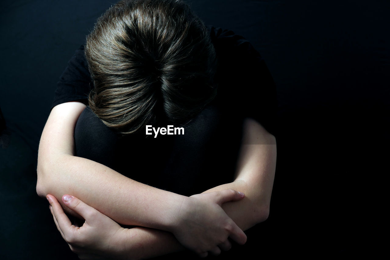 HIGH ANGLE VIEW OF WOMAN WEARING BLACK BACKGROUND