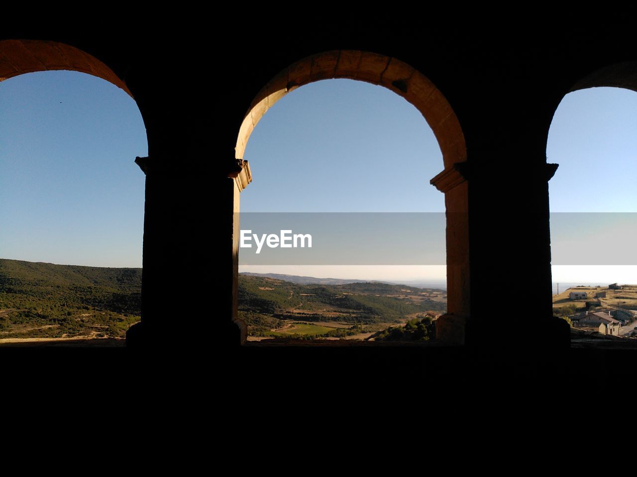 VIEW OF HISTORIC BUILDING SEEN THROUGH WINDOW