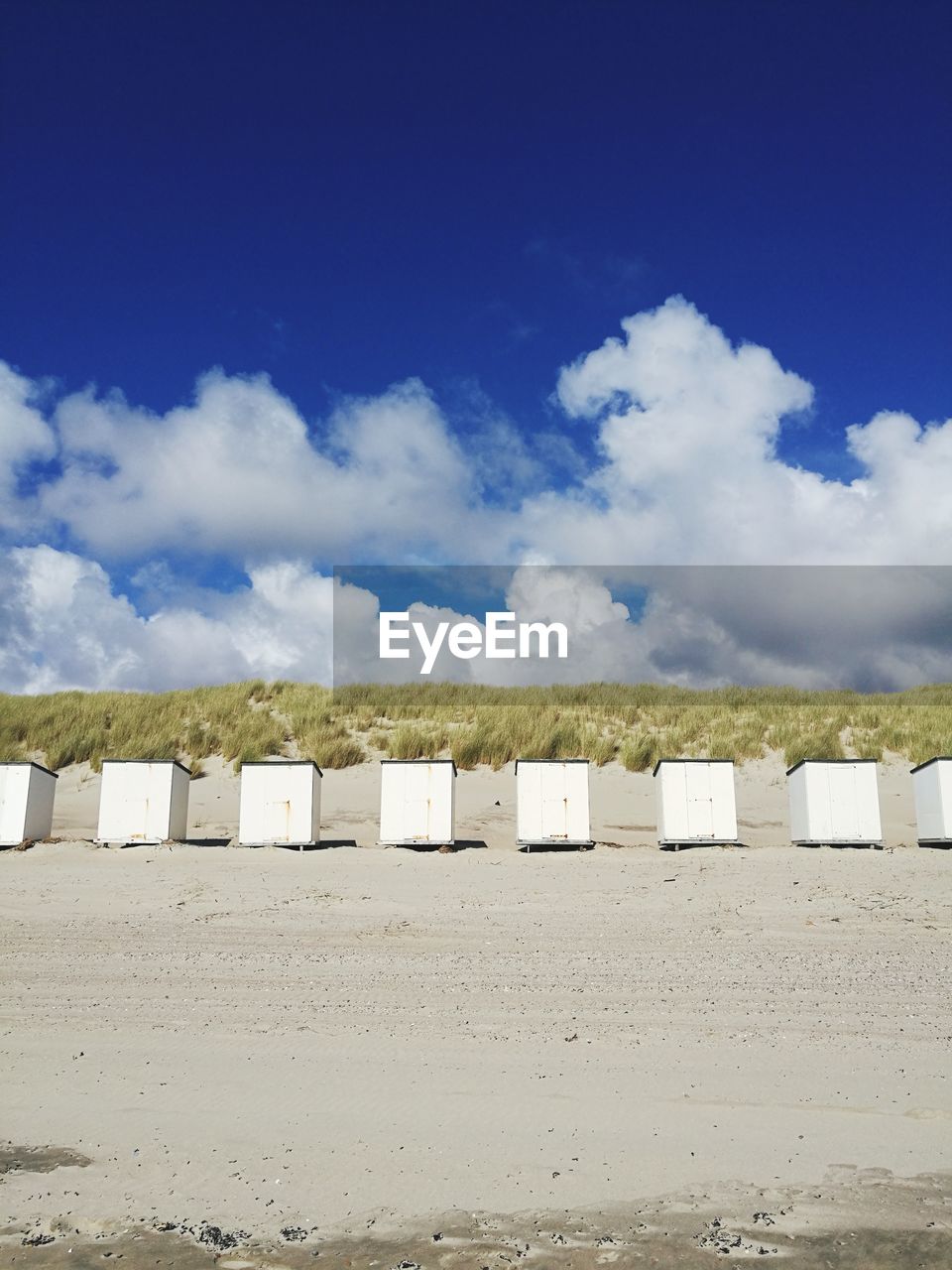 Scenic view of beach against blue sky