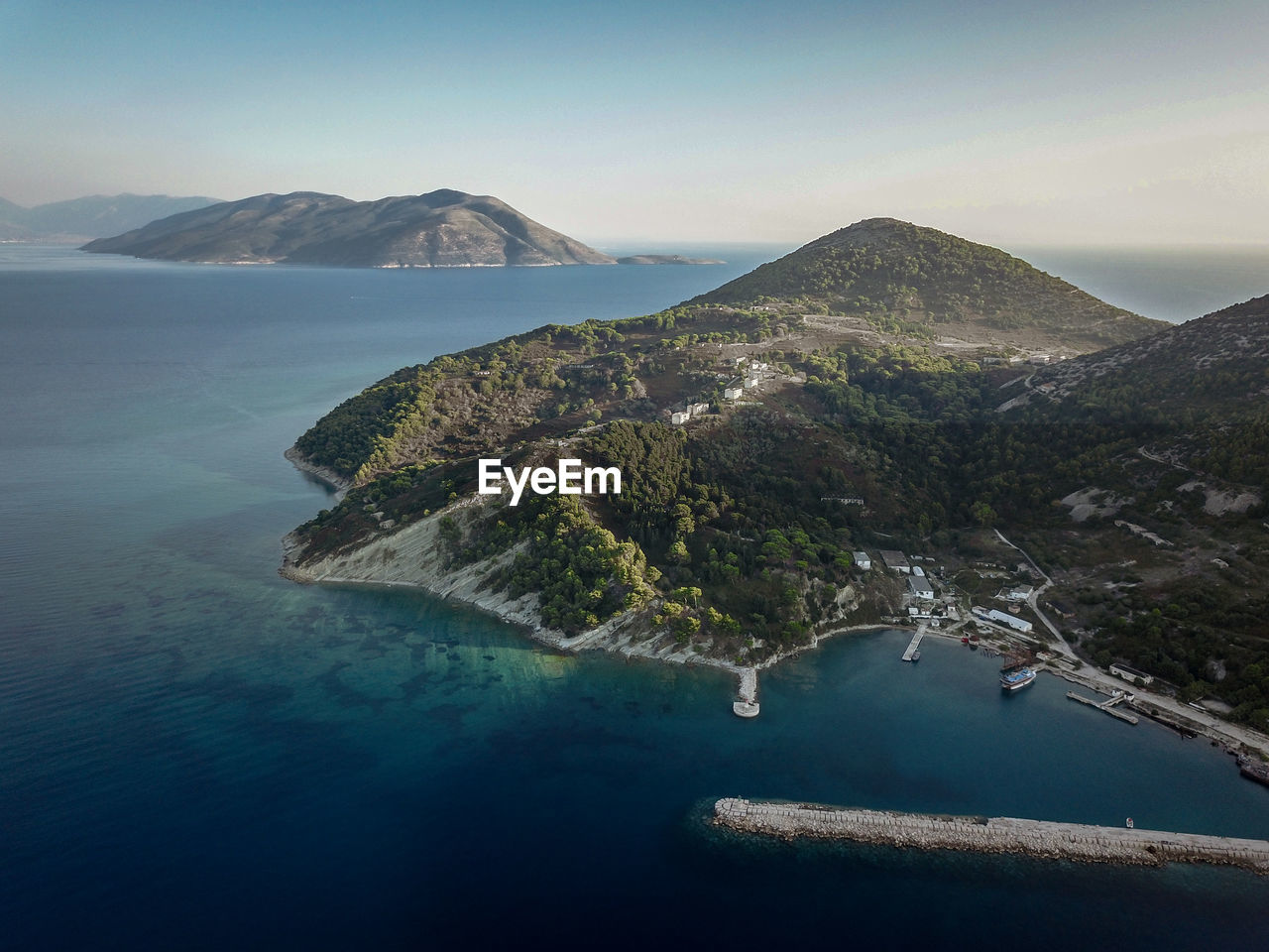 Aerial view of sea and mountains against sky in sazan island 
