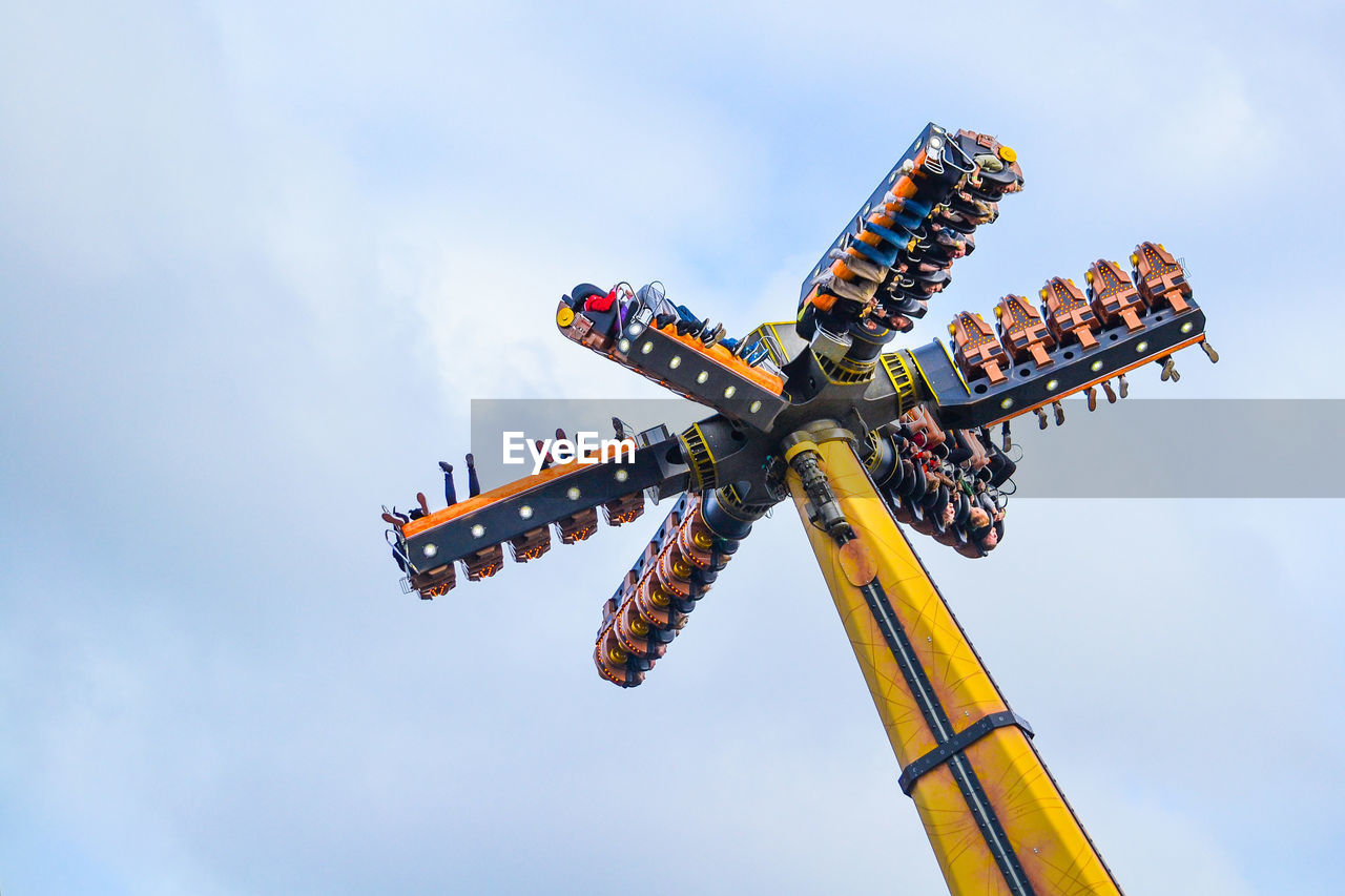 LOW ANGLE VIEW OF ROLLERCOASTER RIDE AGAINST SKY