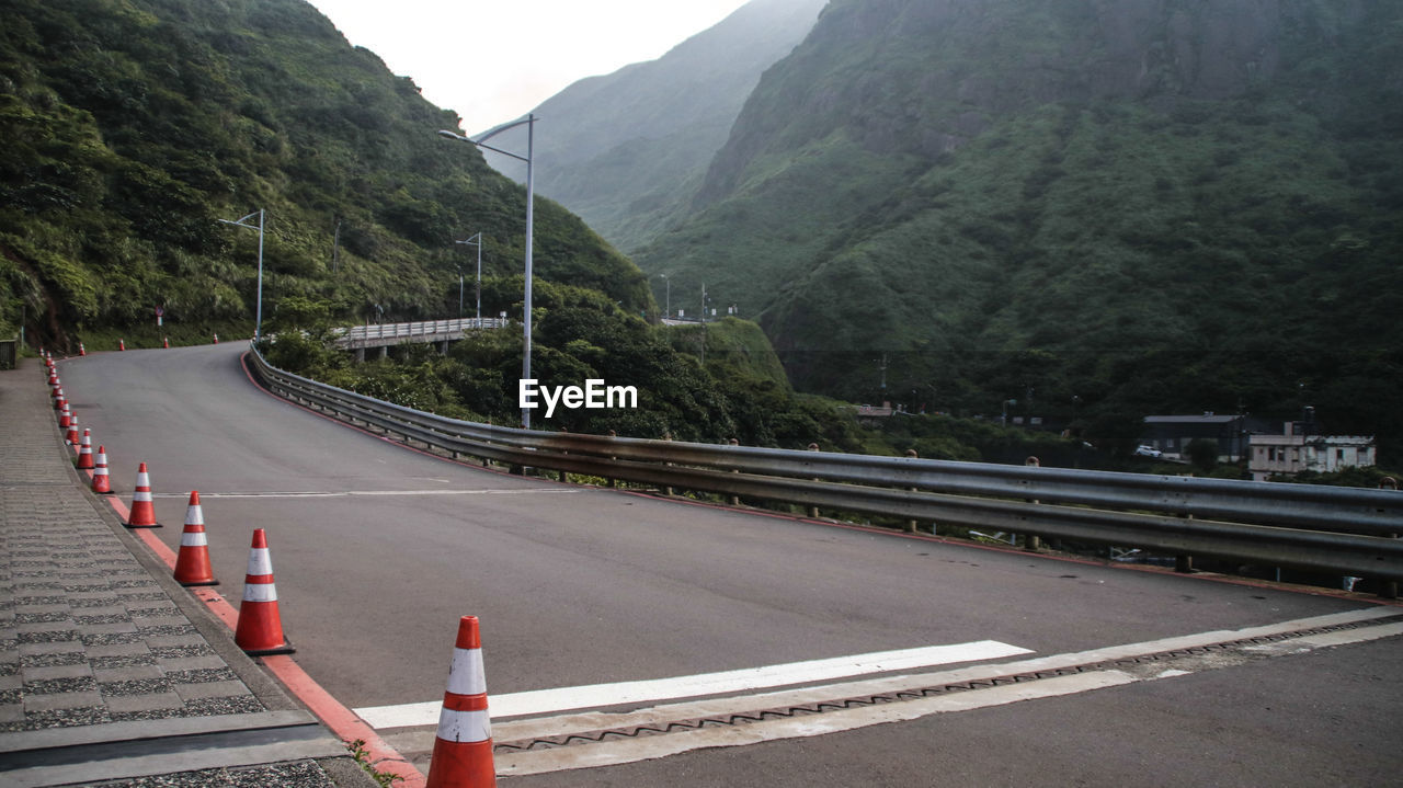 Road by mountain against sky