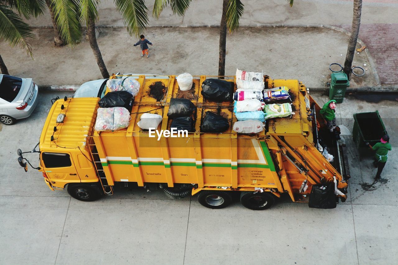 HIGH ANGLE VIEW OF YELLOW CART ON CAR