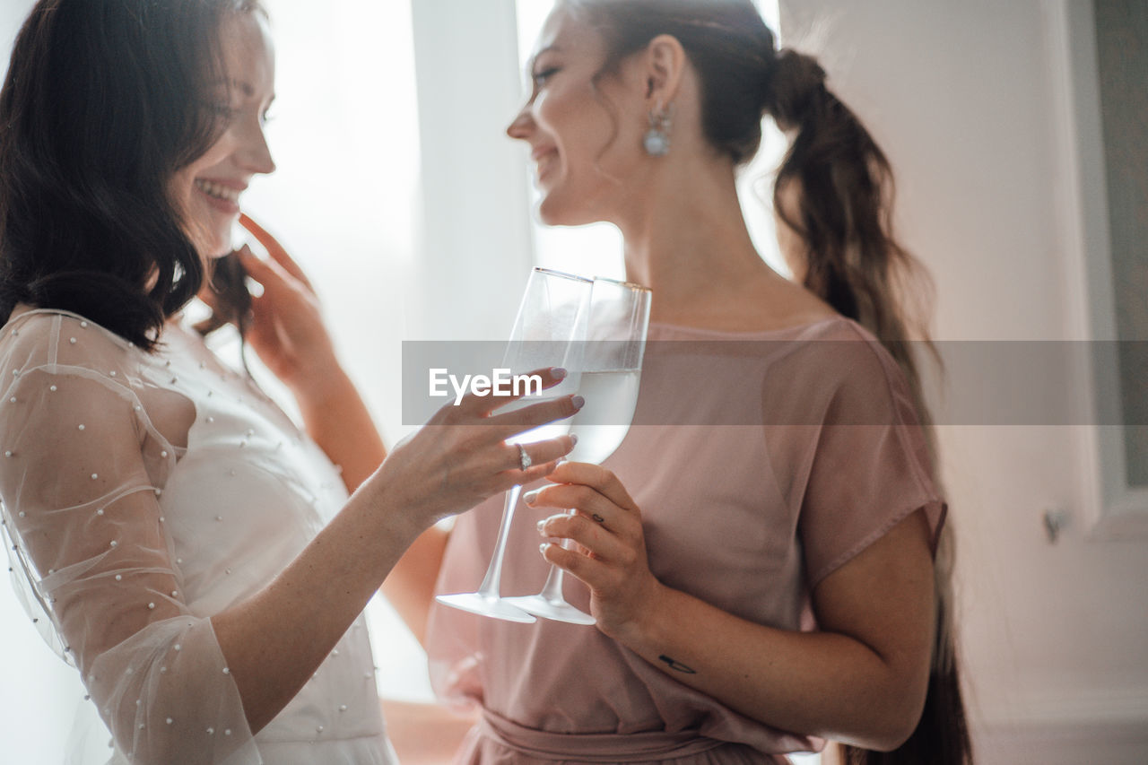 Young woman drinking water from glass