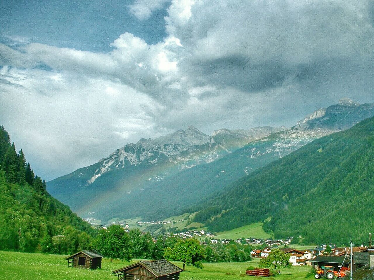 Scenic view of mountains against cloudy sky