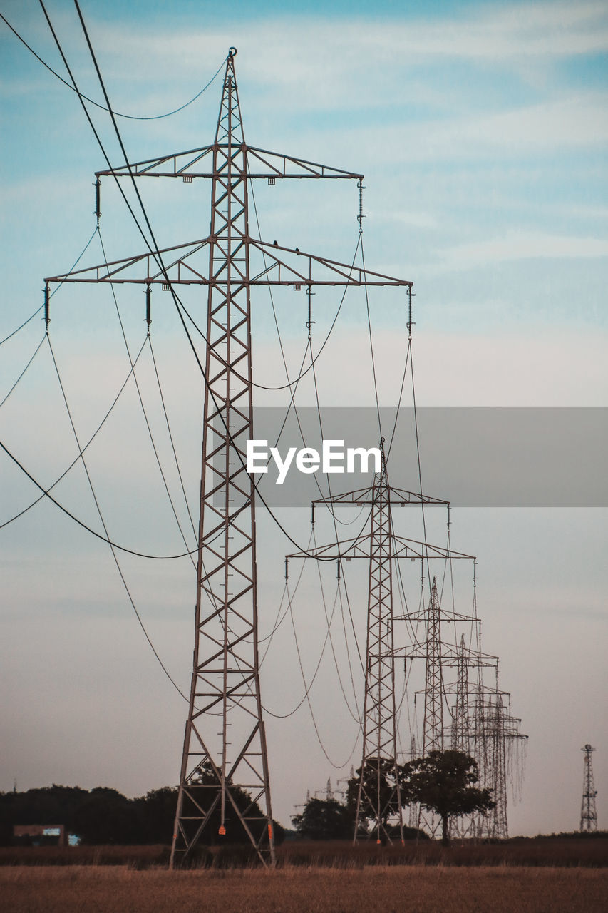 Low angle view of electricity pylon against sky