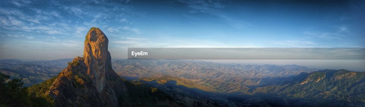 Panoramic view of mountains against blue sky