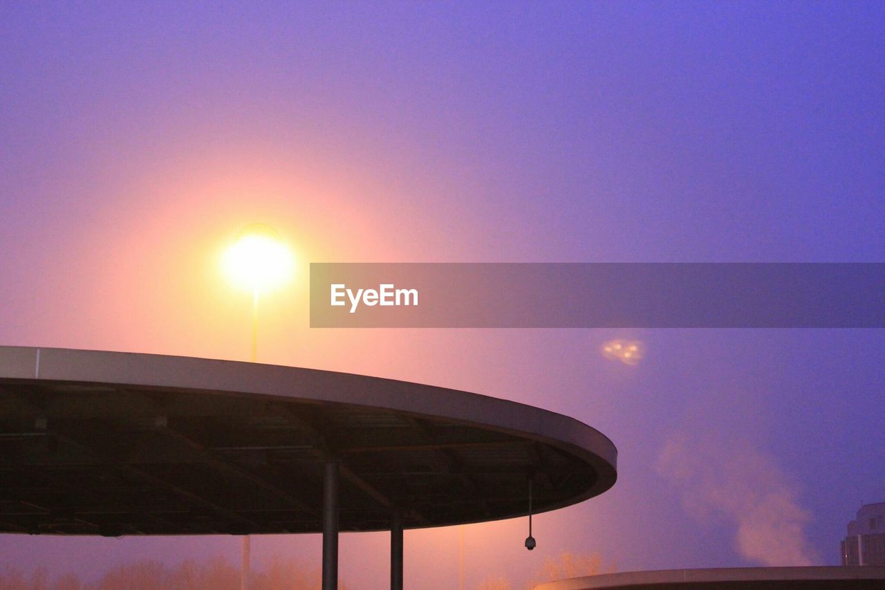 LOW ANGLE VIEW OF BUILT STRUCTURES AT SUNSET