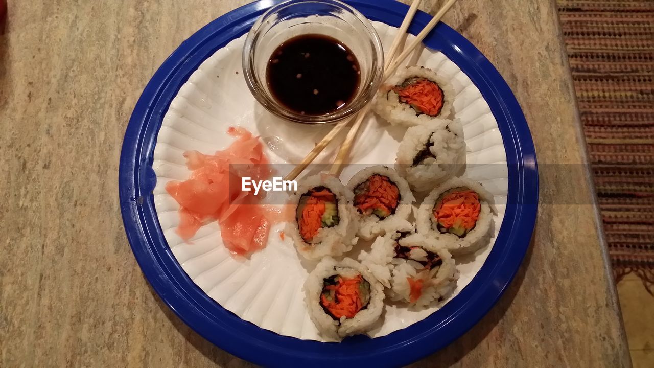 High angle view of sushi in plate with chopsticks