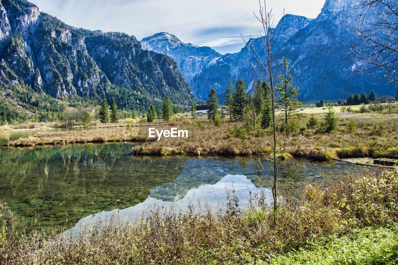 Scenic view of lake and mountains against sky