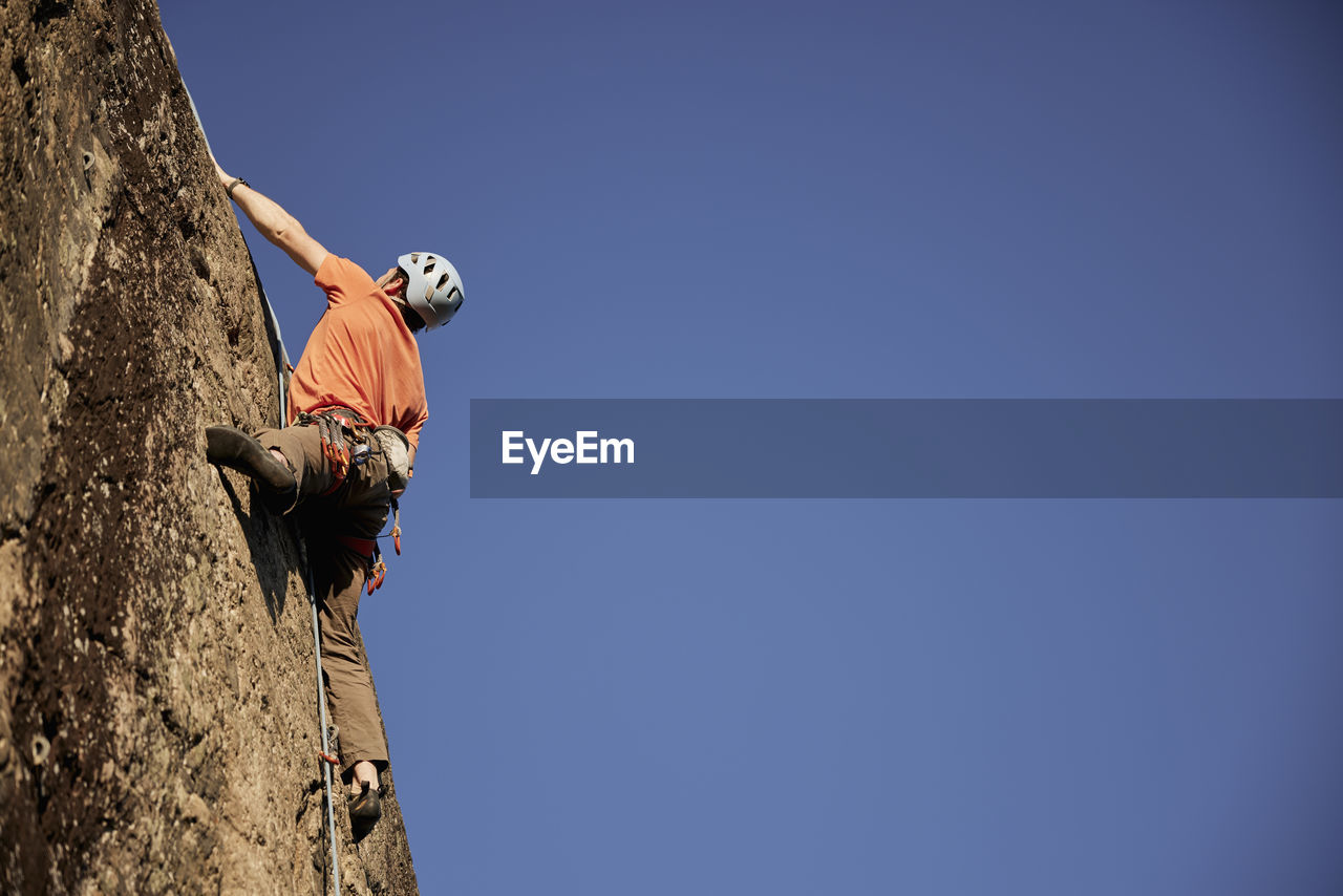 Rock climber reaching top