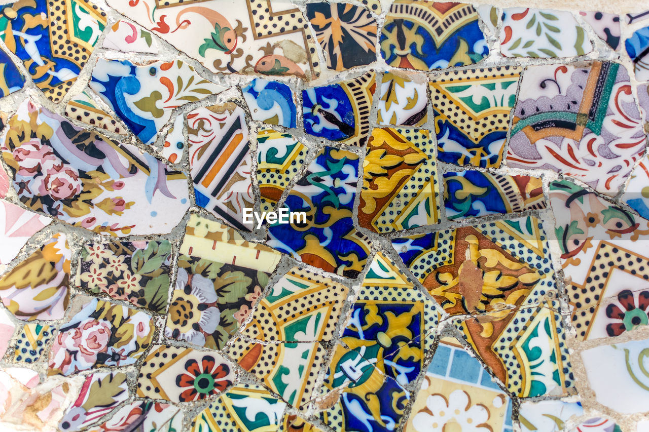 Tile mosaics fragment of serpentine bench in park guell in barcelona