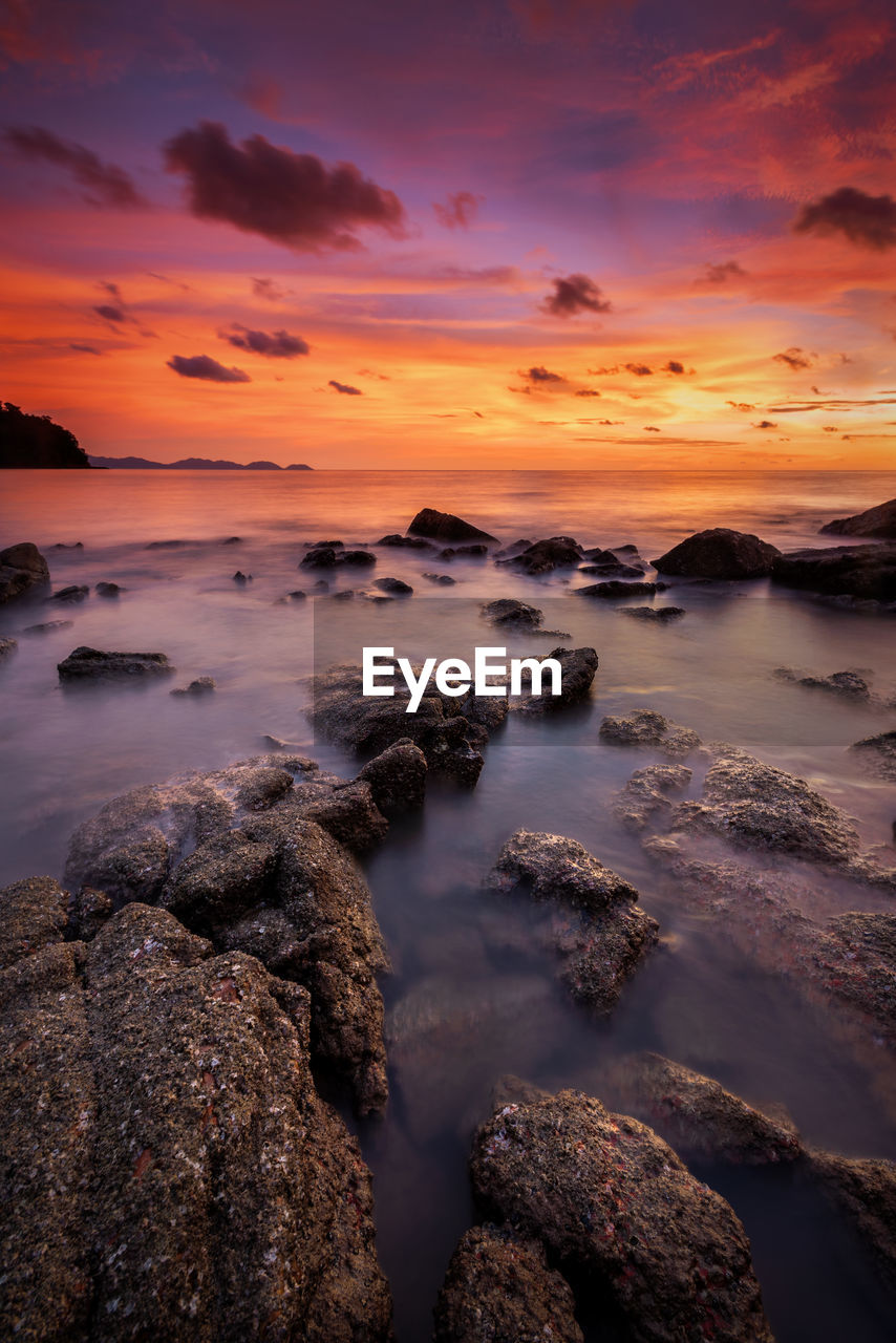 Tranquil sunset over rocky coastal landscape at pulau sayak kuala muda kedah malaysia	
