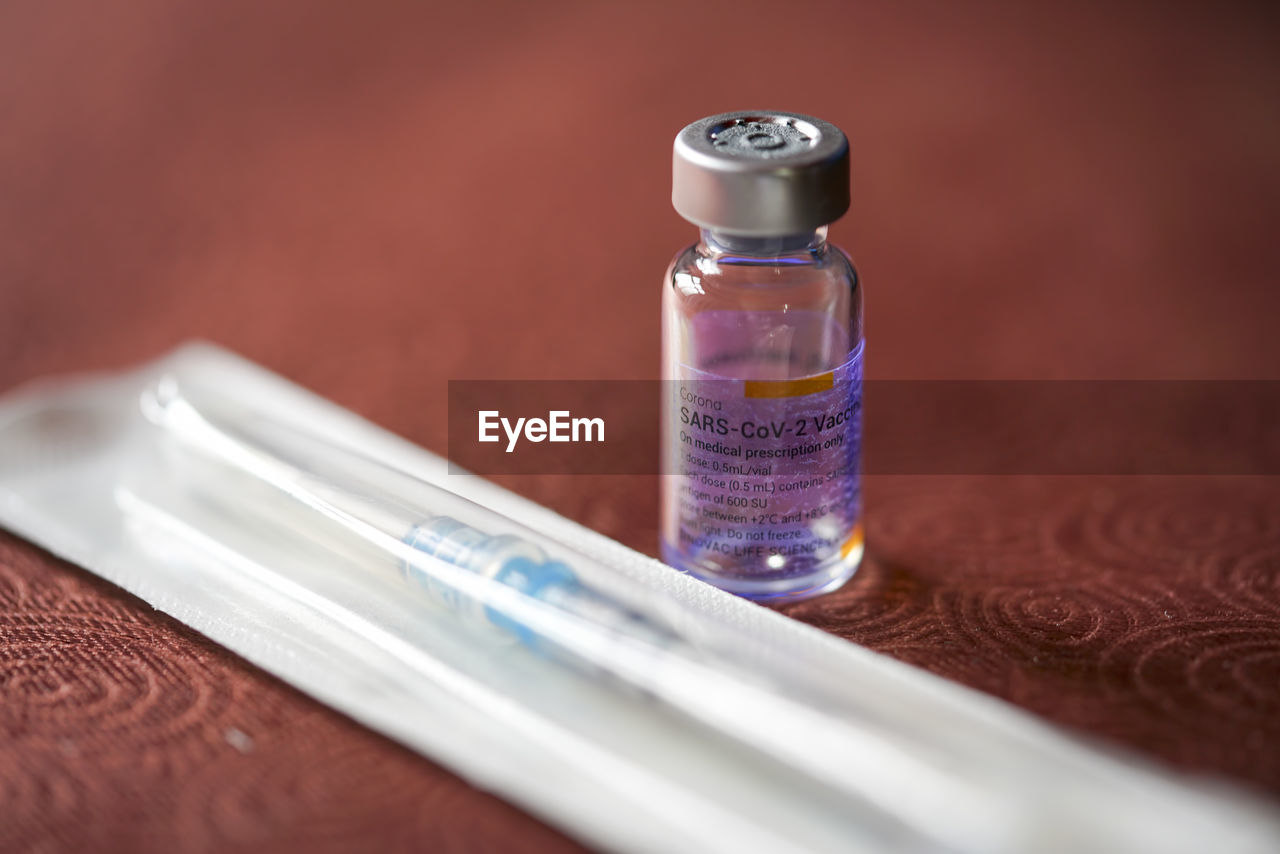 Close up of a corona virus vaccine vial and disposable syringe