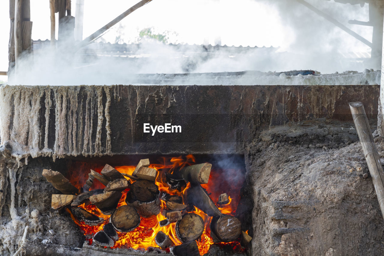 Firewood in a rock salt stove at ban dung, udon thani, thailand