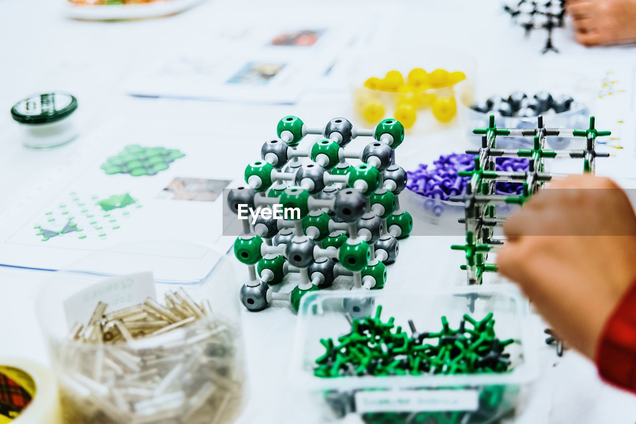 High angle view of hand by toys on table